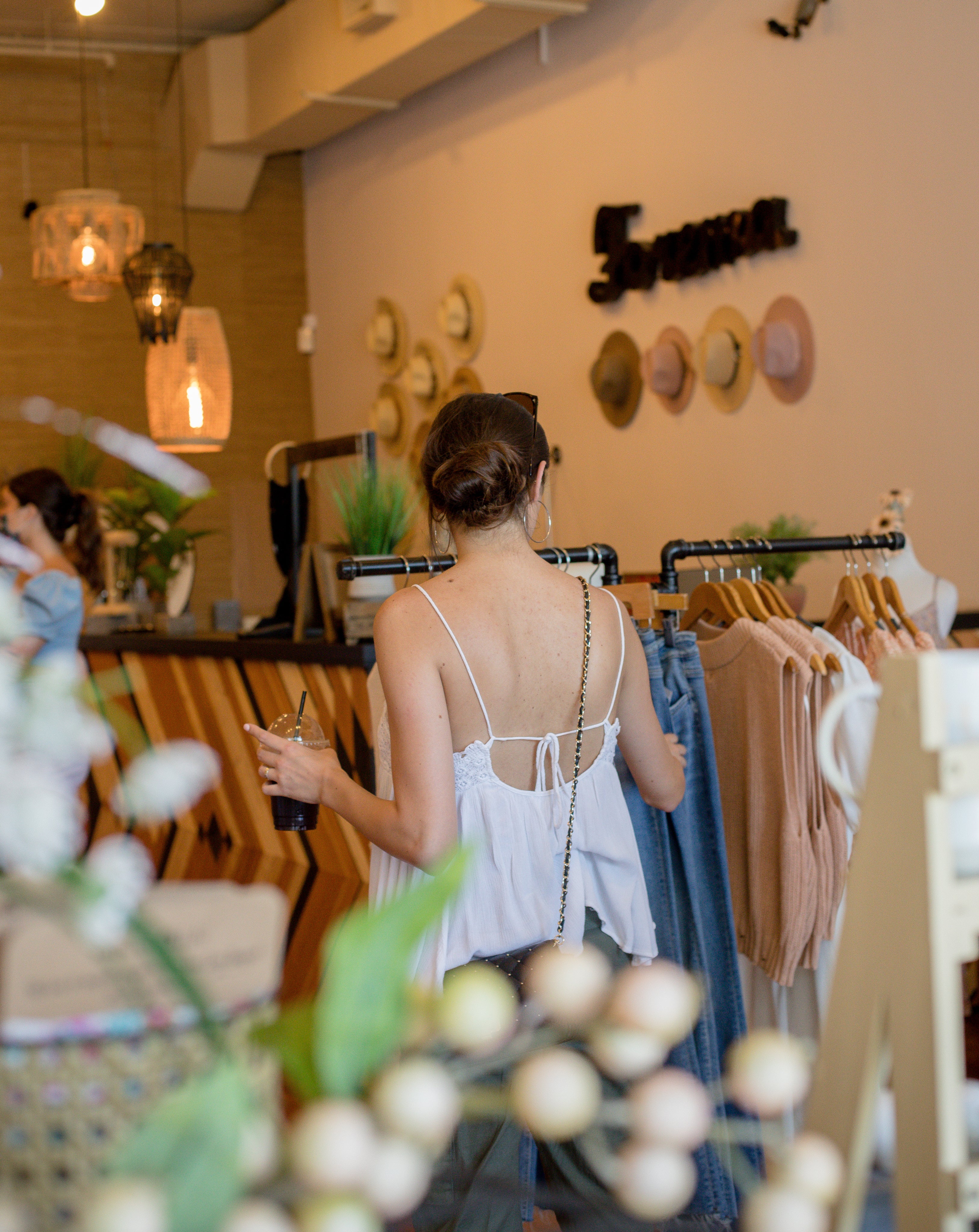 person-browses-clothing-racks-in-a-store.jpg